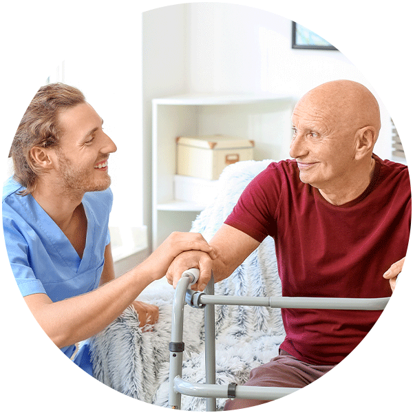Home Health Software | Nurse or clinician helping a patient sitting with a walker - Netsmart myUnity® home health EHR software for clinical documentation, scheduling, and billing