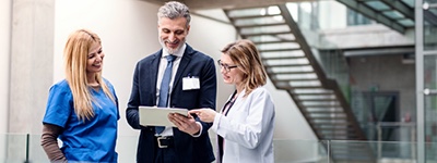 Medical practitioners conferring - Netsmart TheraOffice is the leading physical therapy scheduling, documentation, and billing EMR software