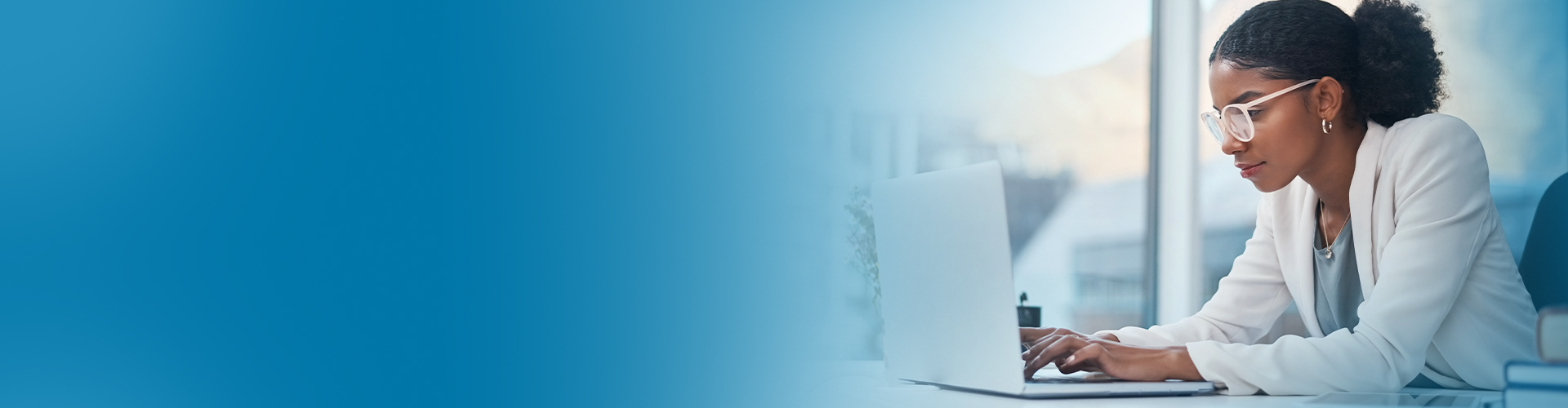 Woman working at a laptop - Netsmart Vital Records System (VRS) registers and issues county and state medical records